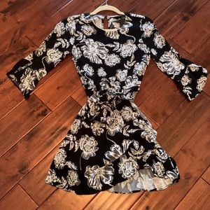 Black and white floral, wrap dress with ruffle detail.